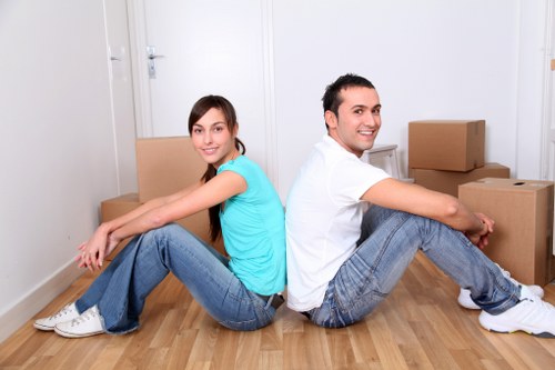 Professional movers carrying furniture in a Streatham property