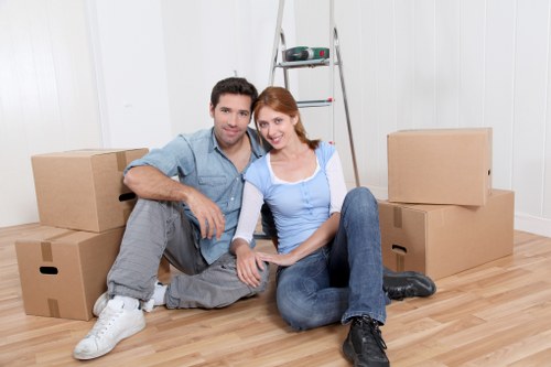 Movers wearing PPE while carrying items safely on site
