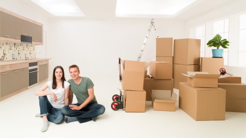 Packed boxes and furniture ready for urgent removals in a Streatham property